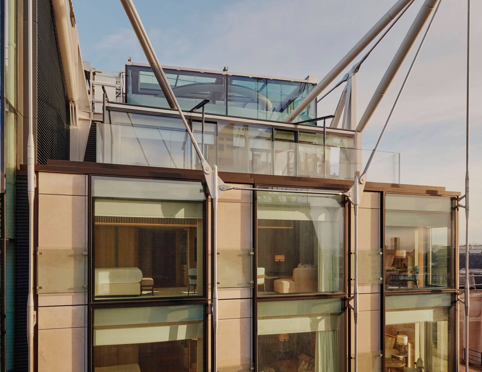 The Emory's modern facade showcases floor-to-ceiling windows, reflecting bespoke interiors and architectural harmony under its striking steel frame.